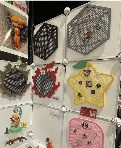 Display wall with geometric shaped pin/figure boards at convention